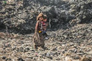 Syrians scavenging burning waste